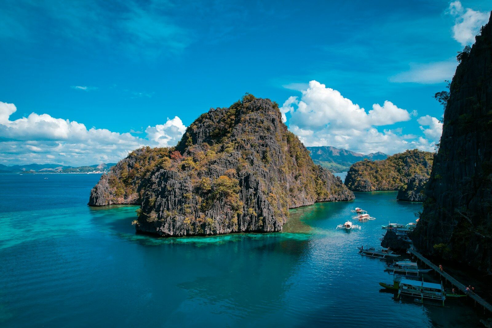 a group of boats floating on top of a body of water