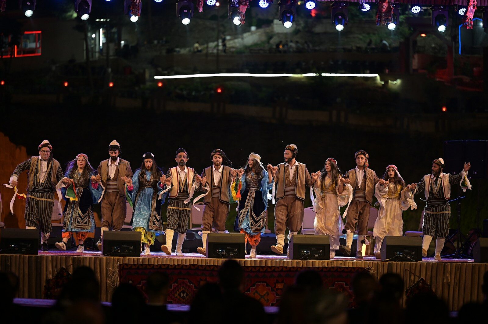 People are performing a dance on stage.